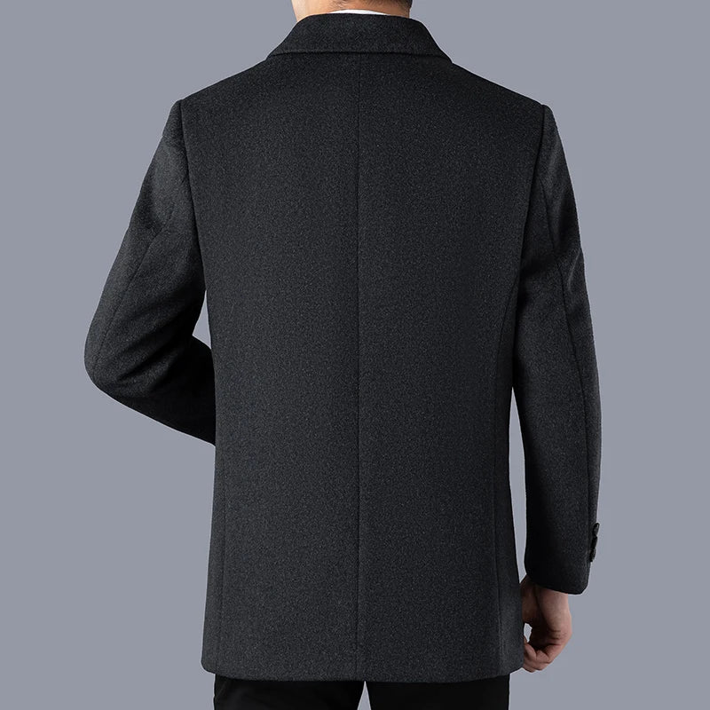 Dark gray coat worn by a person on a gray background