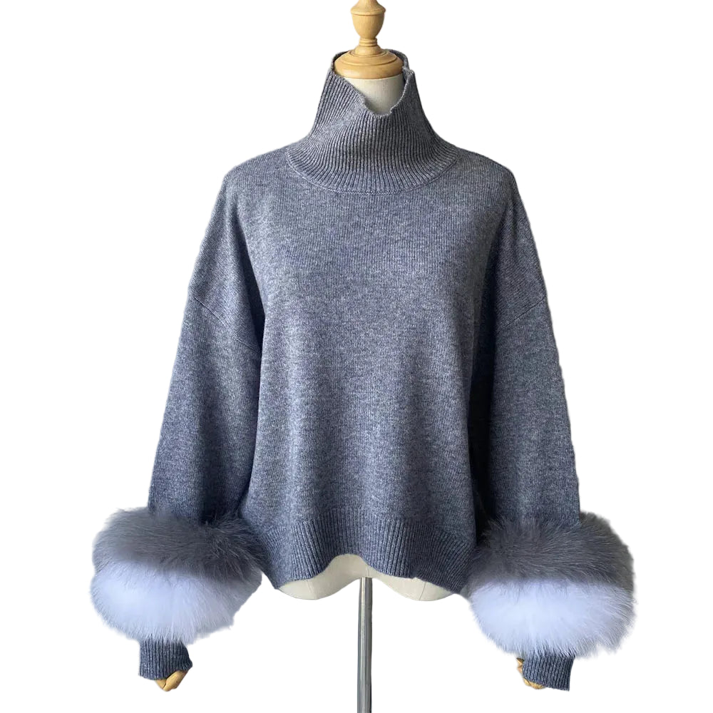 Gray sweater with fur cuffs on a mannequin against a plain background