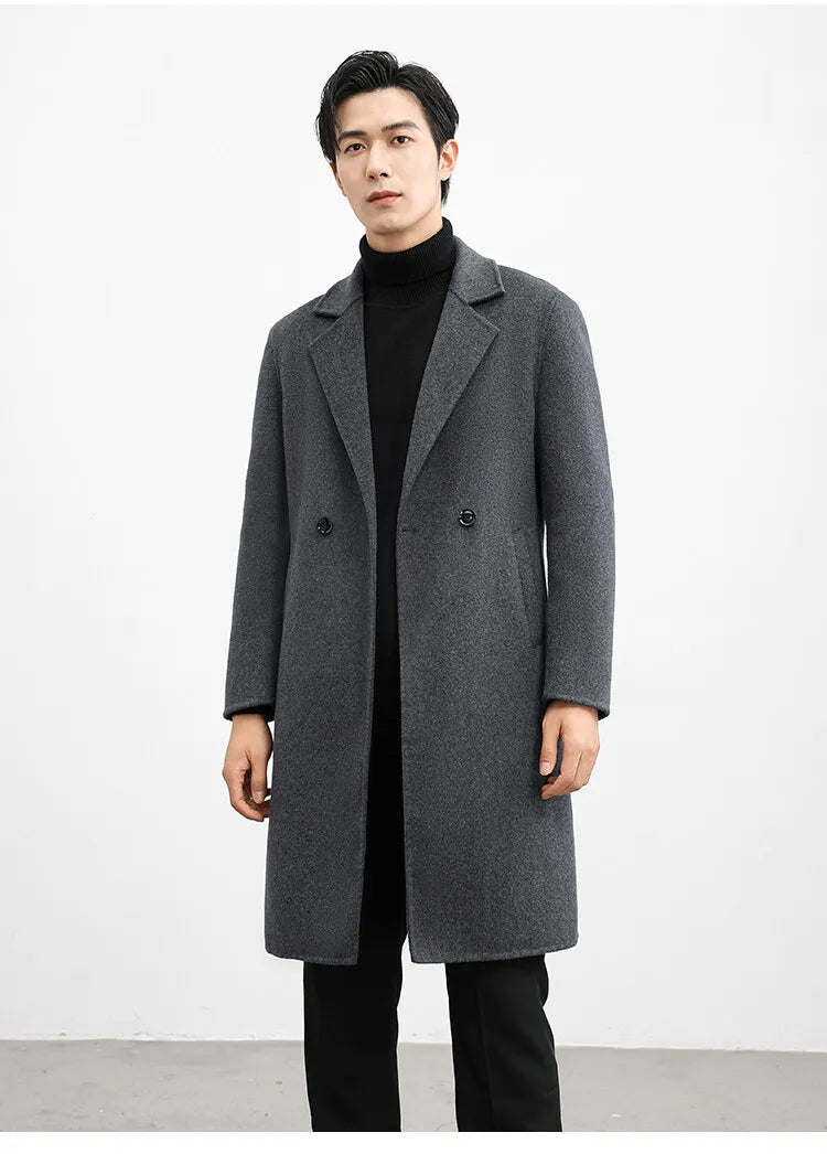Man wearing a gray overcoat against a white background