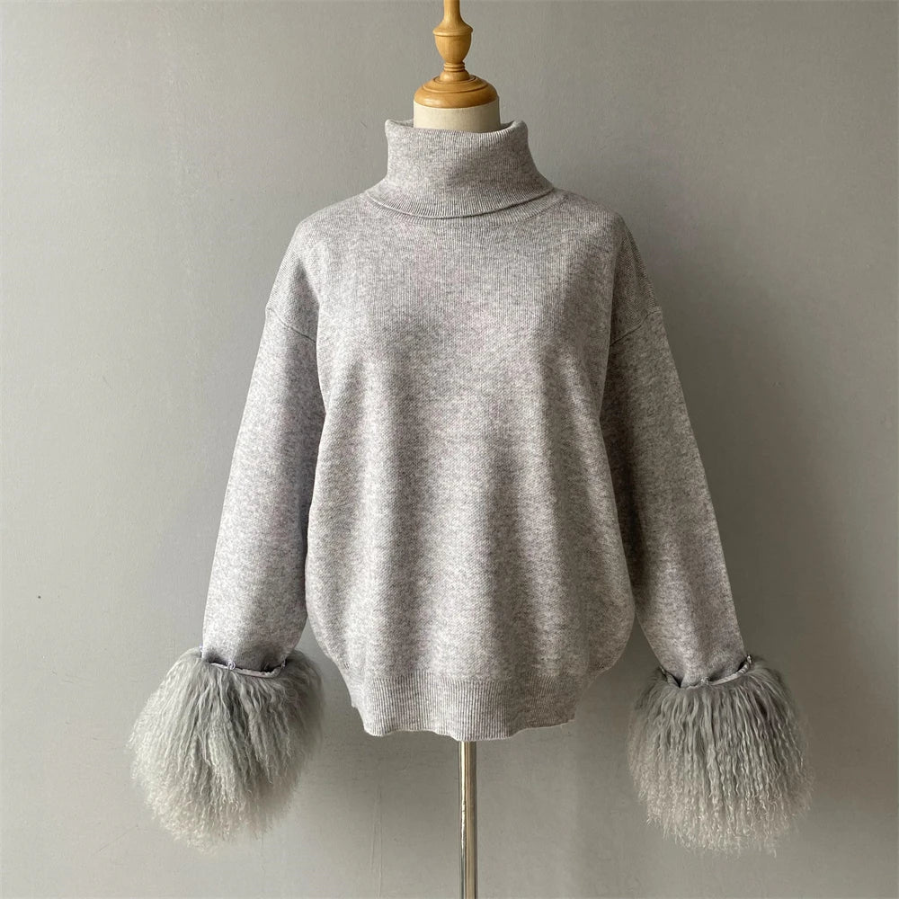 Gray sweater with fringed cuffs on a mannequin against a plain background