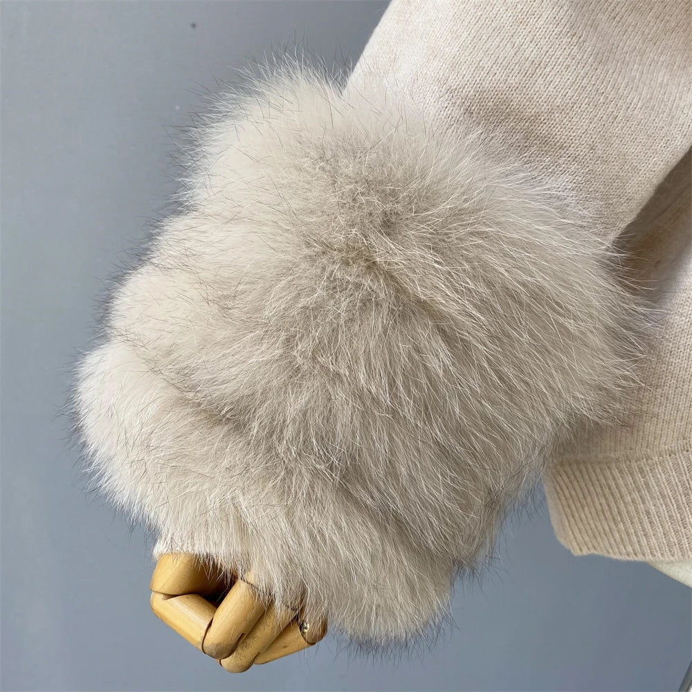 Close-up of a beige sweater with fluffy cuffs on a gray background