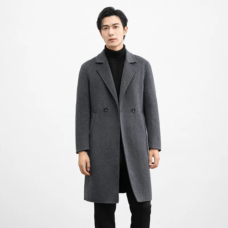Man wearing a gray overcoat on a white background
