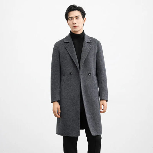 Man wearing a gray overcoat on a white background