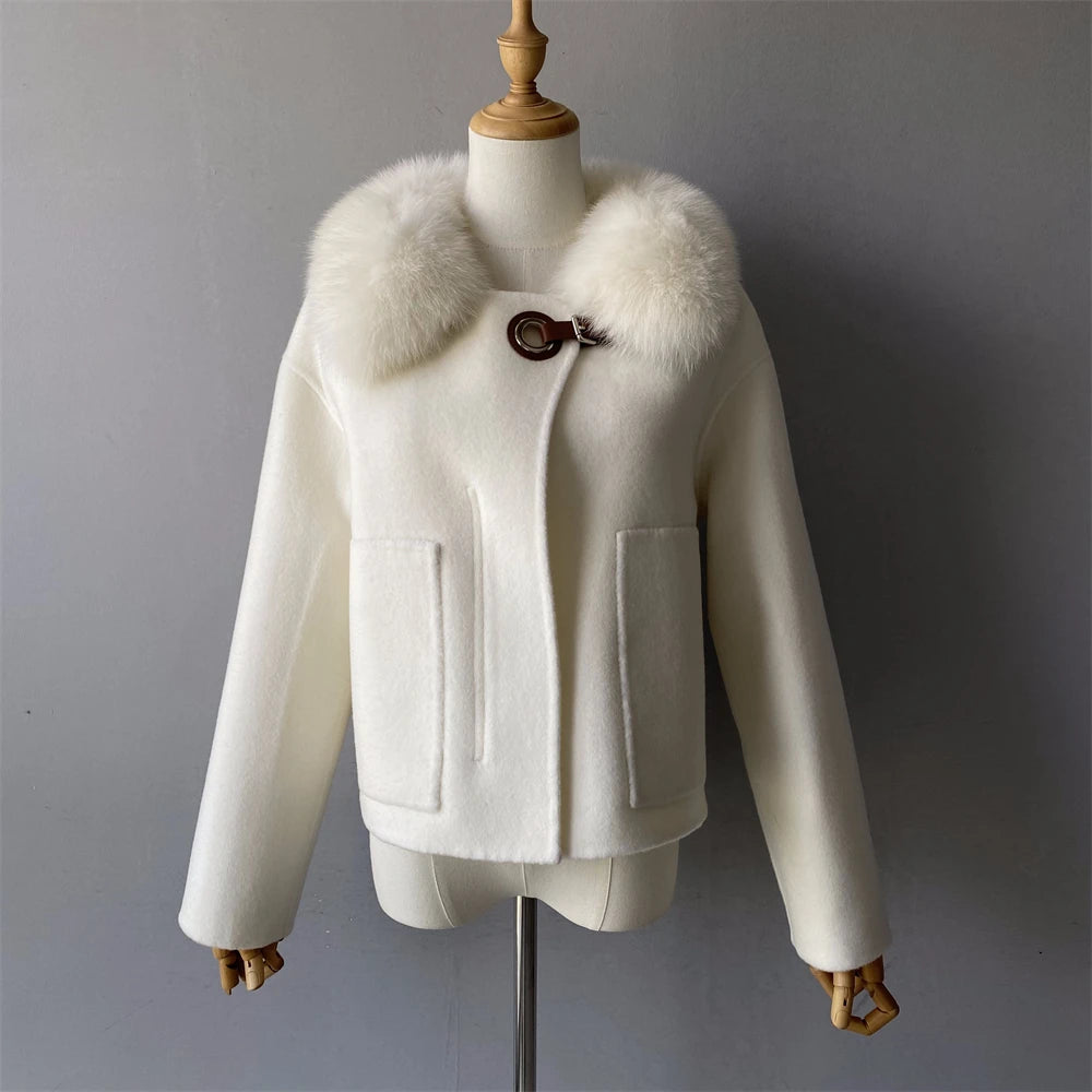 White coat with fur collar on a mannequin against a gray background