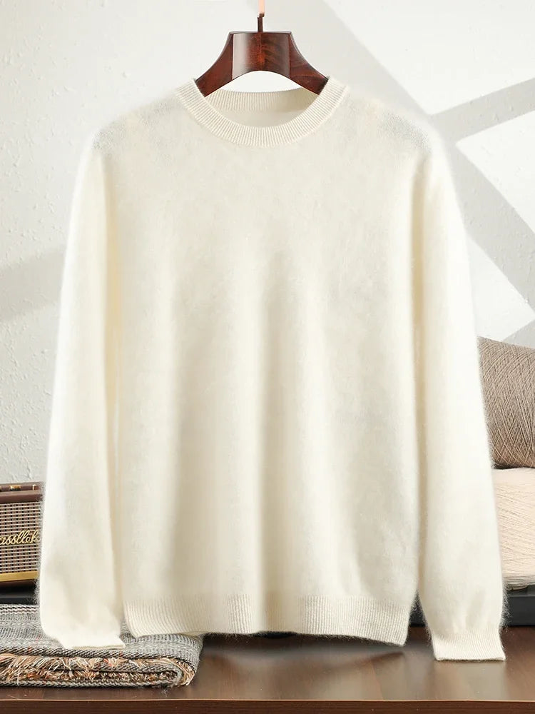 White sweater on a wooden hanger against a neutral background