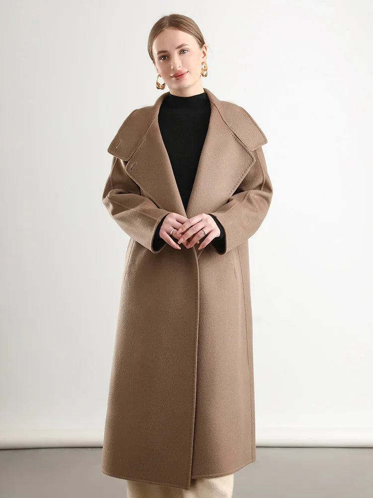 Woman wearing a beige coat against a white background