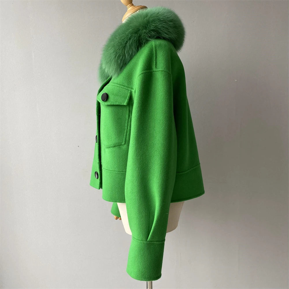 Green coat with fur collar on a mannequin against a plain background