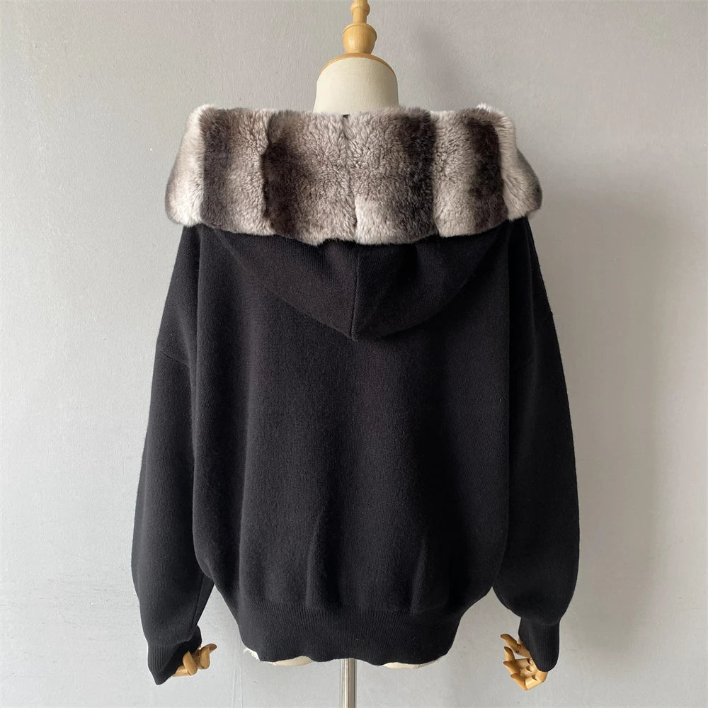 Black hoodie with fur-lined hood on a mannequin against a plain background
