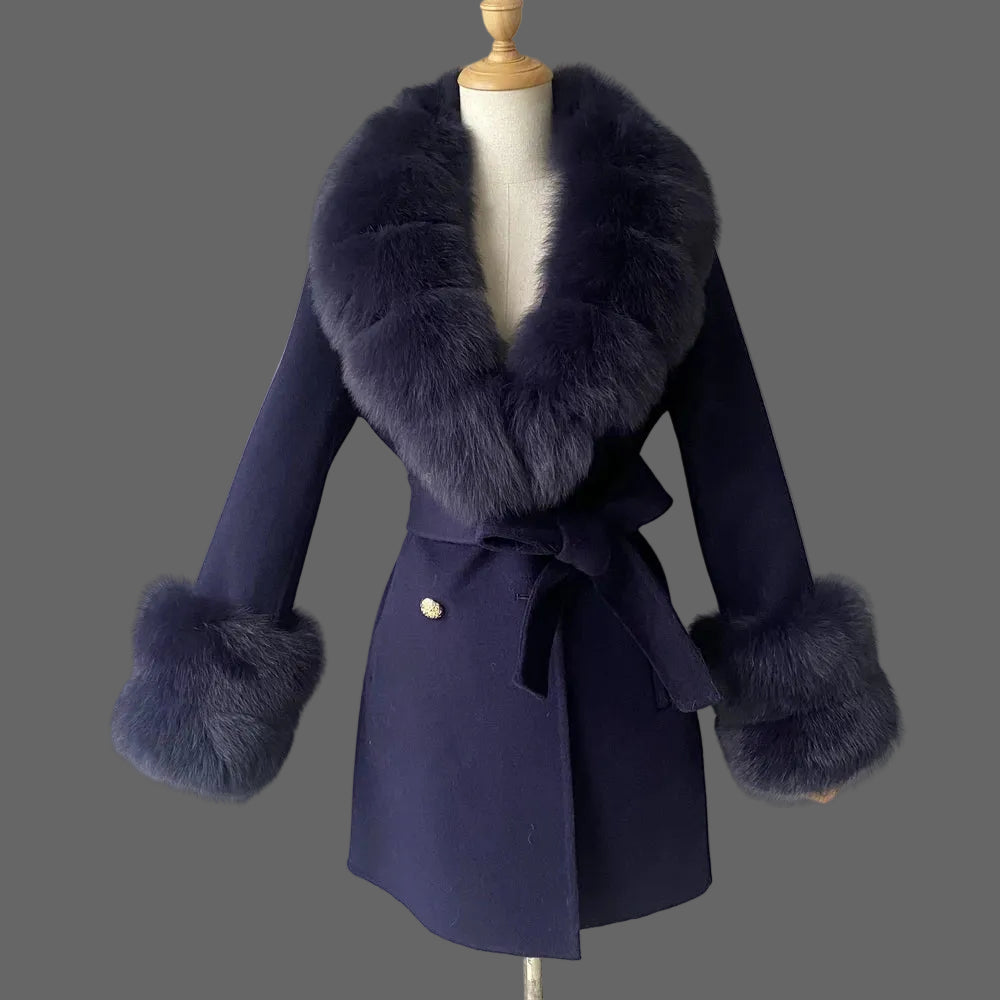 Navy blue coat with fur accents on a mannequin against a plain background
