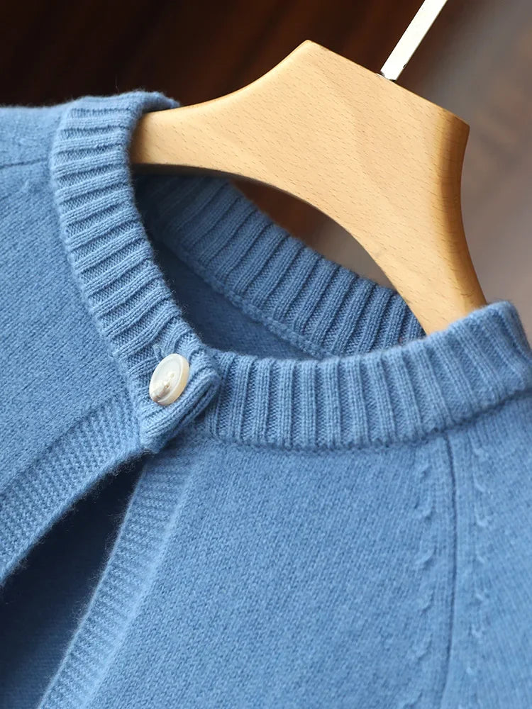 Close-up of a blue knitted sweater on a wooden hanger
