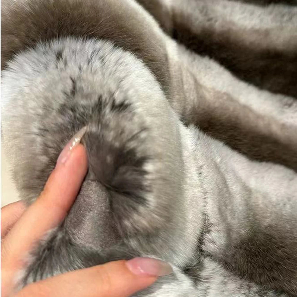 Close-up of a fluffy gray fabric with a hand touching it