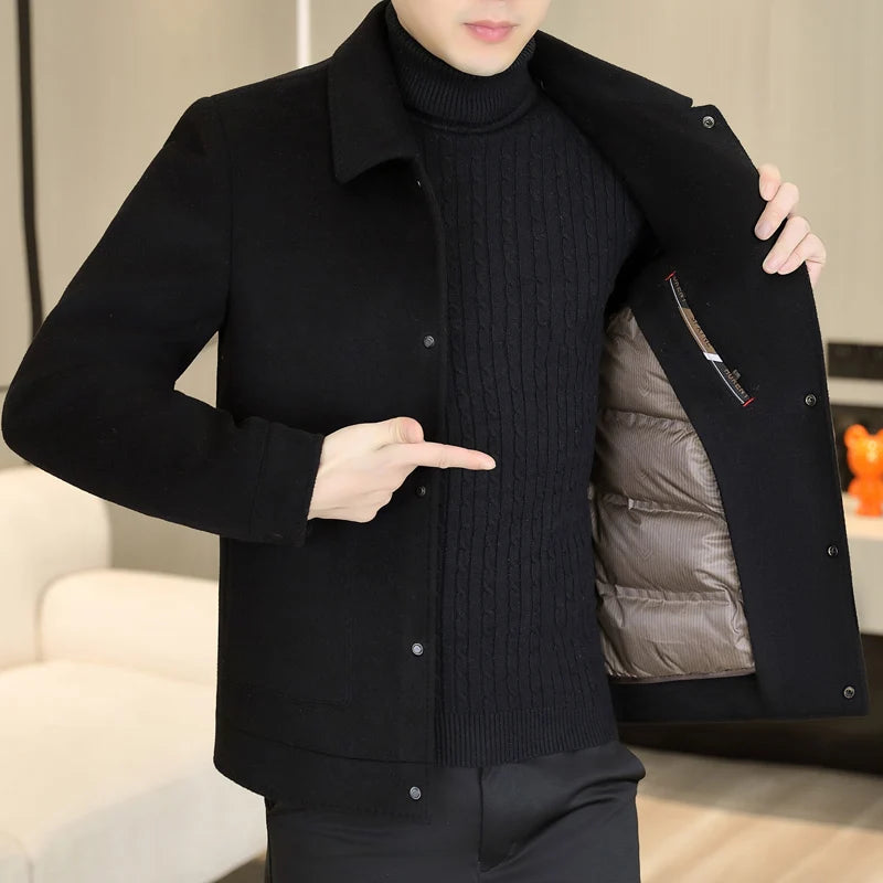 Person wearing a black coat with a textured inner lining, pointing to the inside.