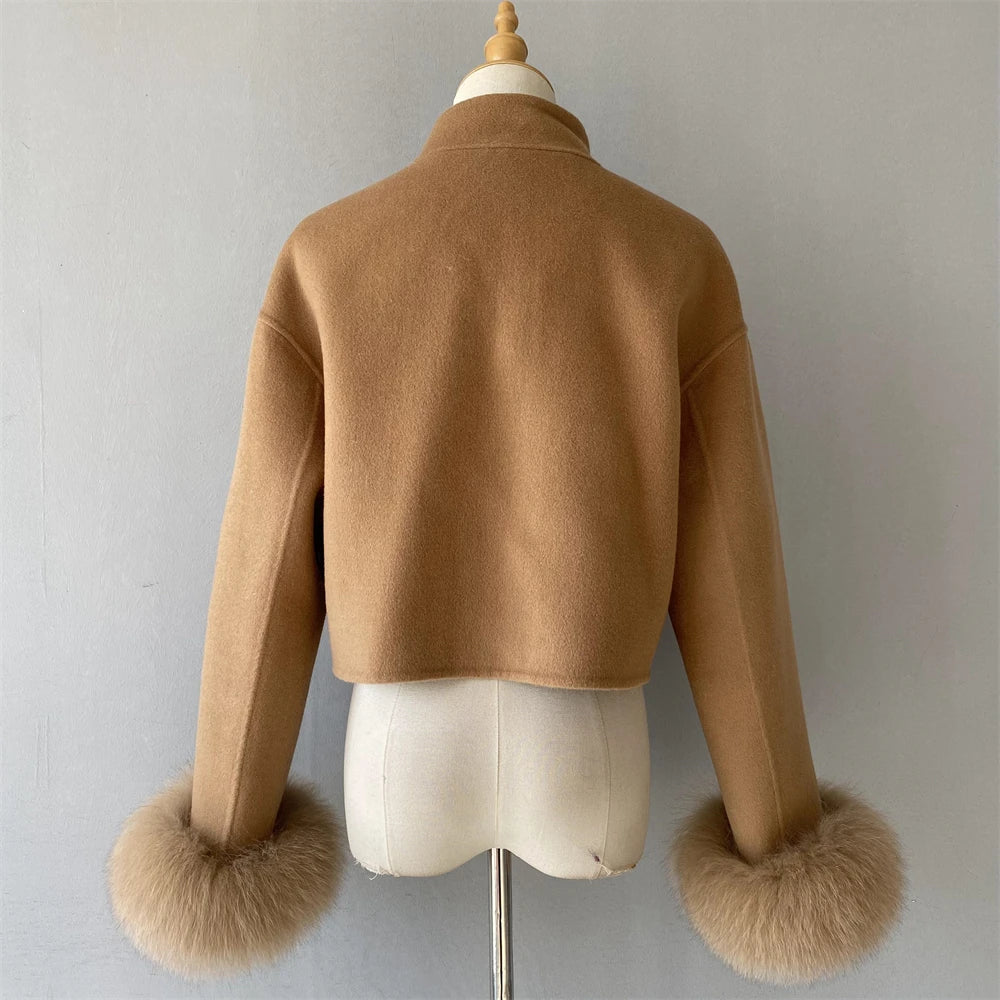 Brown jacket with fur cuffs on a mannequin against a plain background