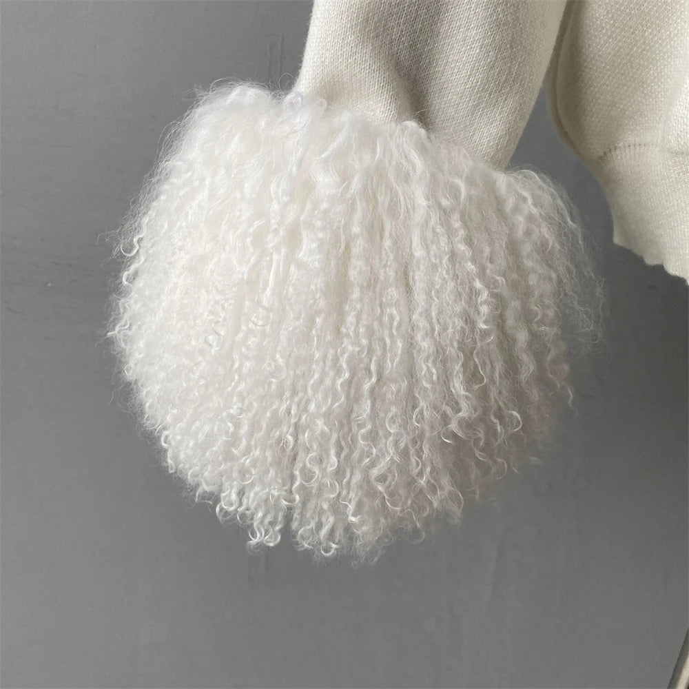 Close-up of a fluffy white pom-pom on a neutral background