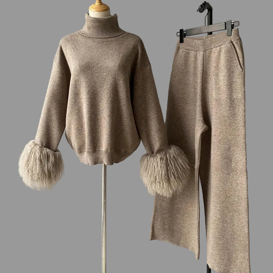 Beige sweater and pants set with fluffy cuffs on a gray background