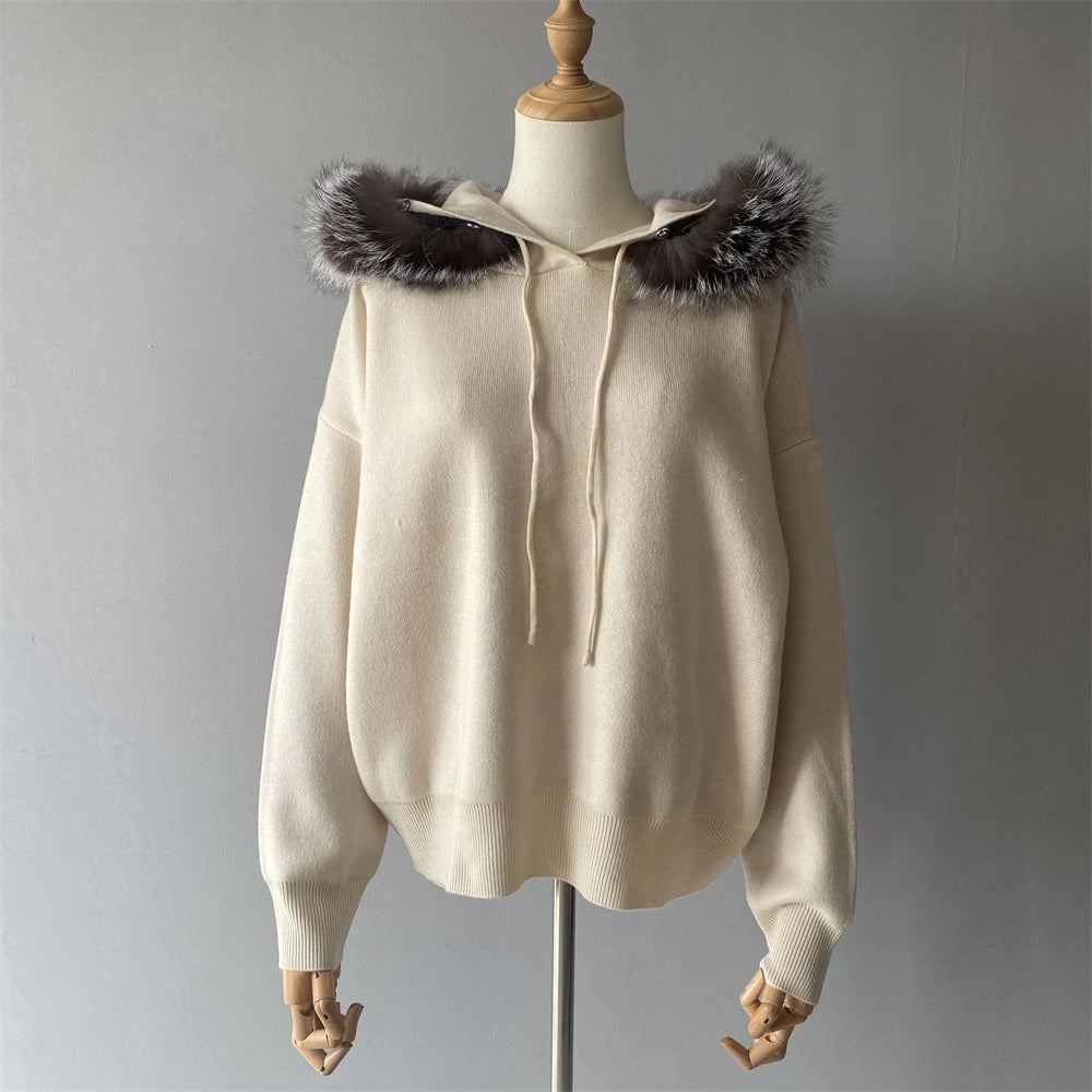 Beige hoodie with fur trim on a mannequin against a gray background