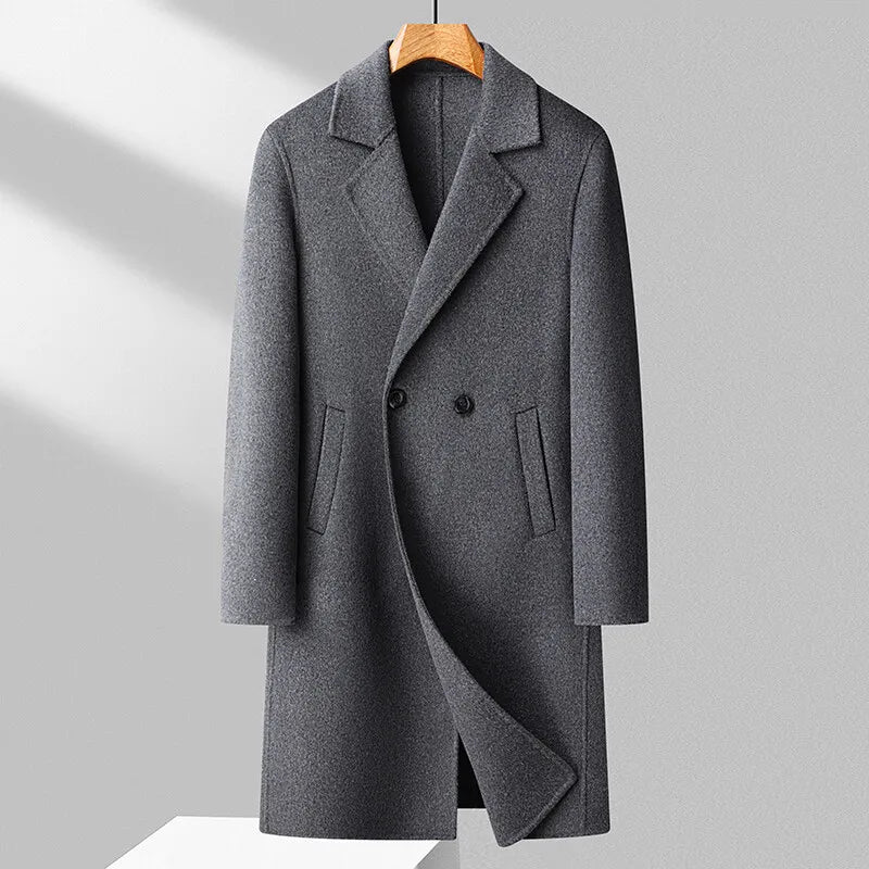 Gray coat on a wooden hanger against a light gray background