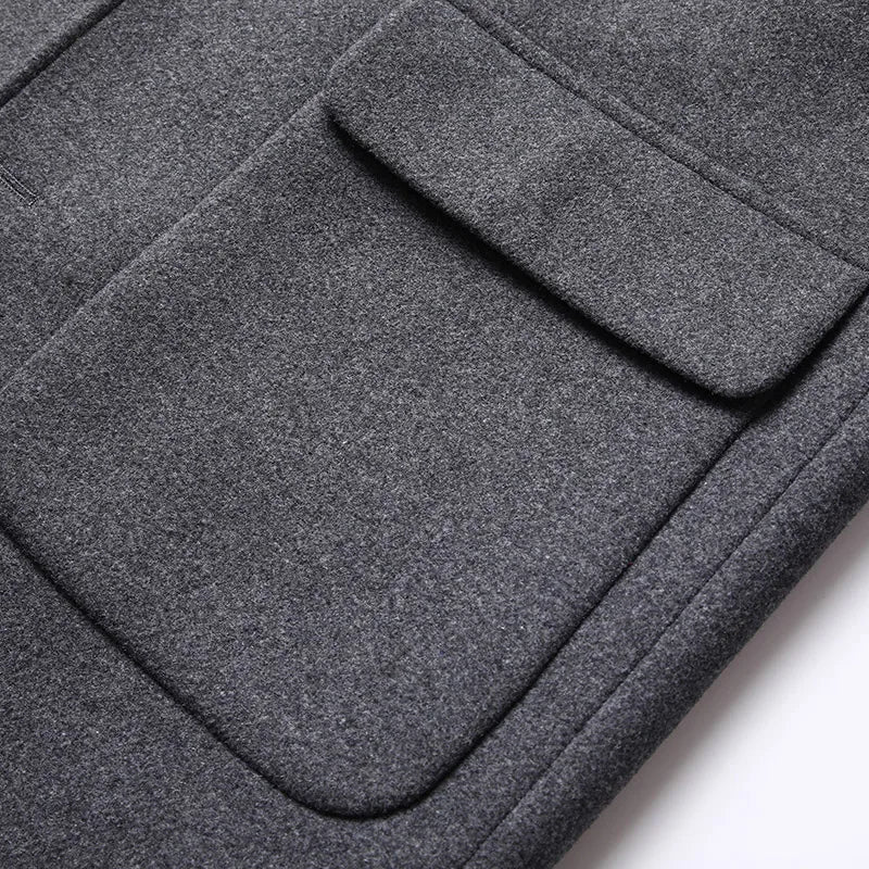 Close-up of a gray fabric with a pocket detail on a white background