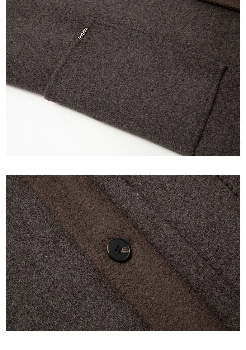 Close-up of a dark gray fabric with a button, part of a coat, on a white background.