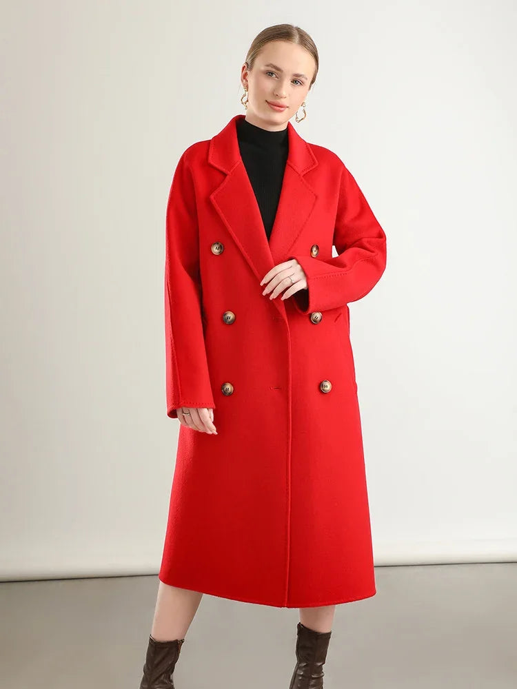 Woman wearing a red coat with gold buttons on a plain background