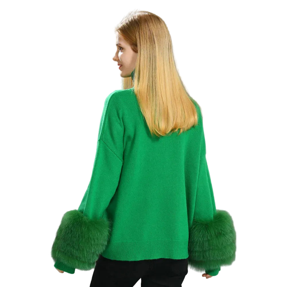 Woman wearing a green sweater with fur cuffs on a gray background