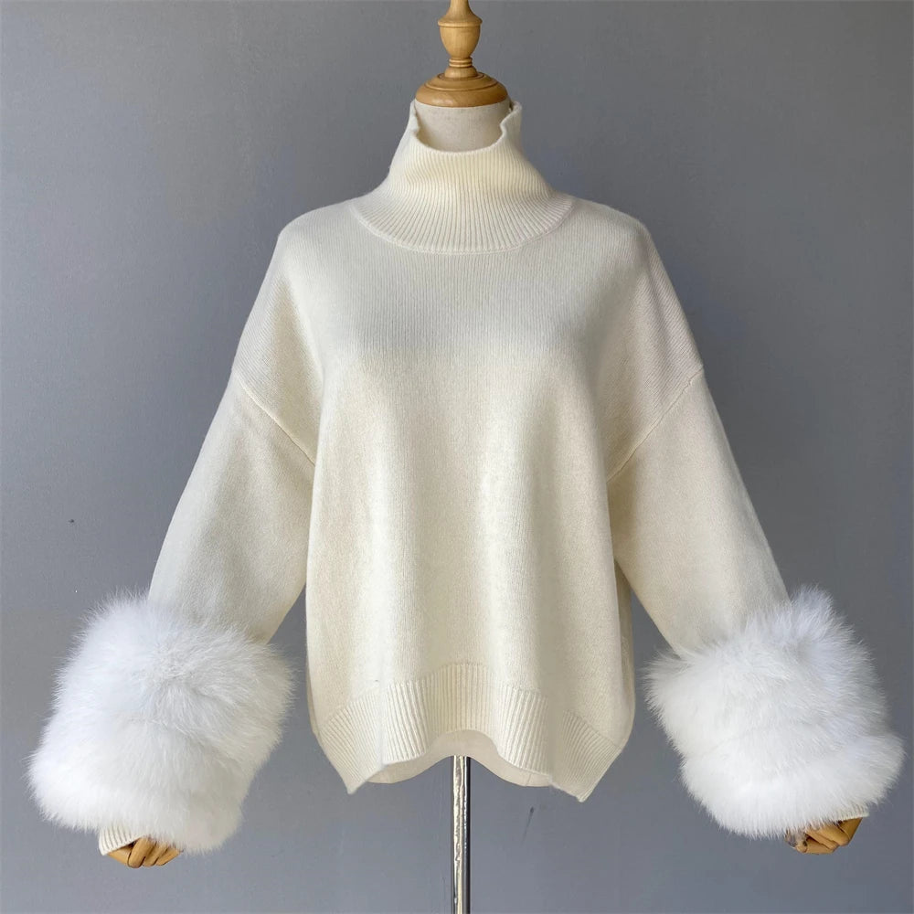 White sweater with fur cuffs on a mannequin against a gray background