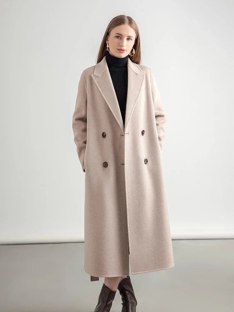Woman wearing a beige coat against a white background