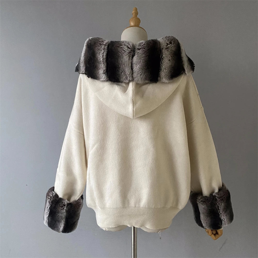 Beige sweater with fur trim on a mannequin against a gray background