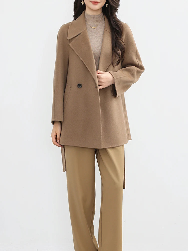 Woman wearing a beige suit on a white background