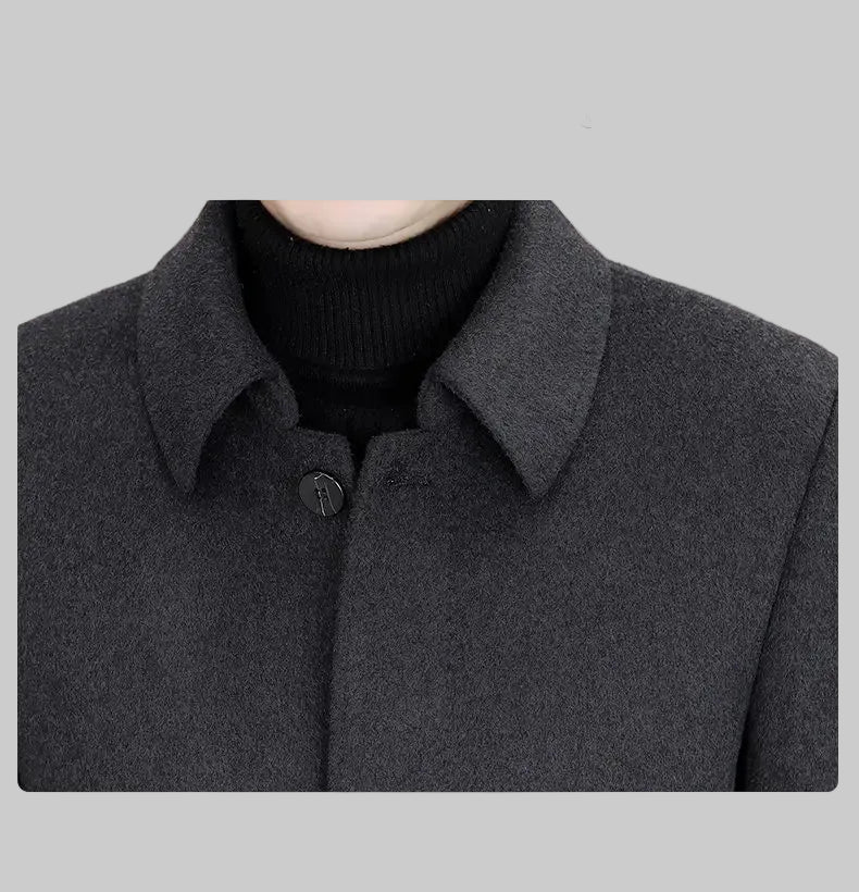 Close-up of a dark gray coat with a collar, focusing on the neck area.