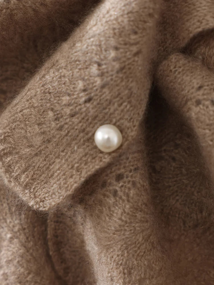 Close-up of a brown fabric with a pearl button