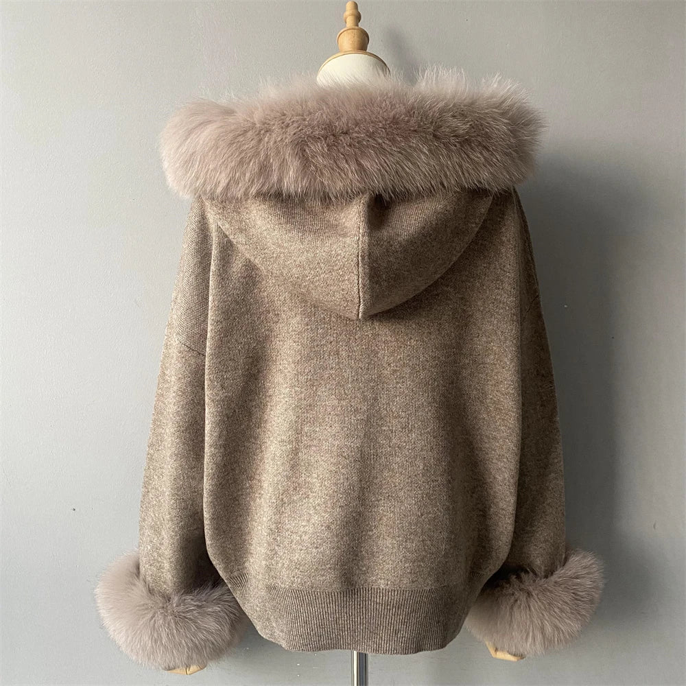 Beige hooded coat with fur trim on a mannequin against a plain background
