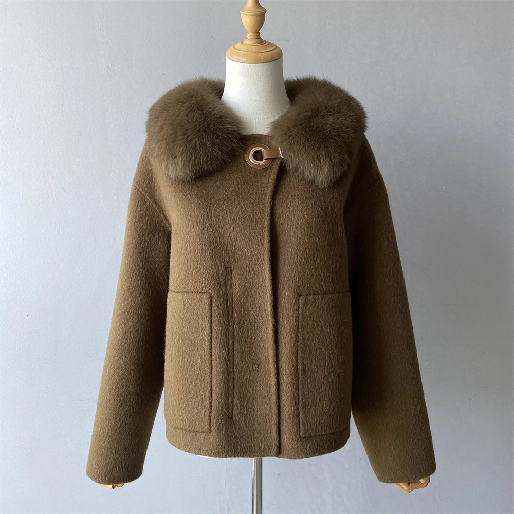 Brown coat with fur collar on a mannequin against a plain background