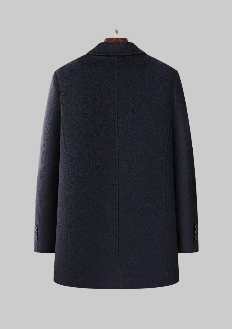 Navy blue coat on a mannequin against a gray background