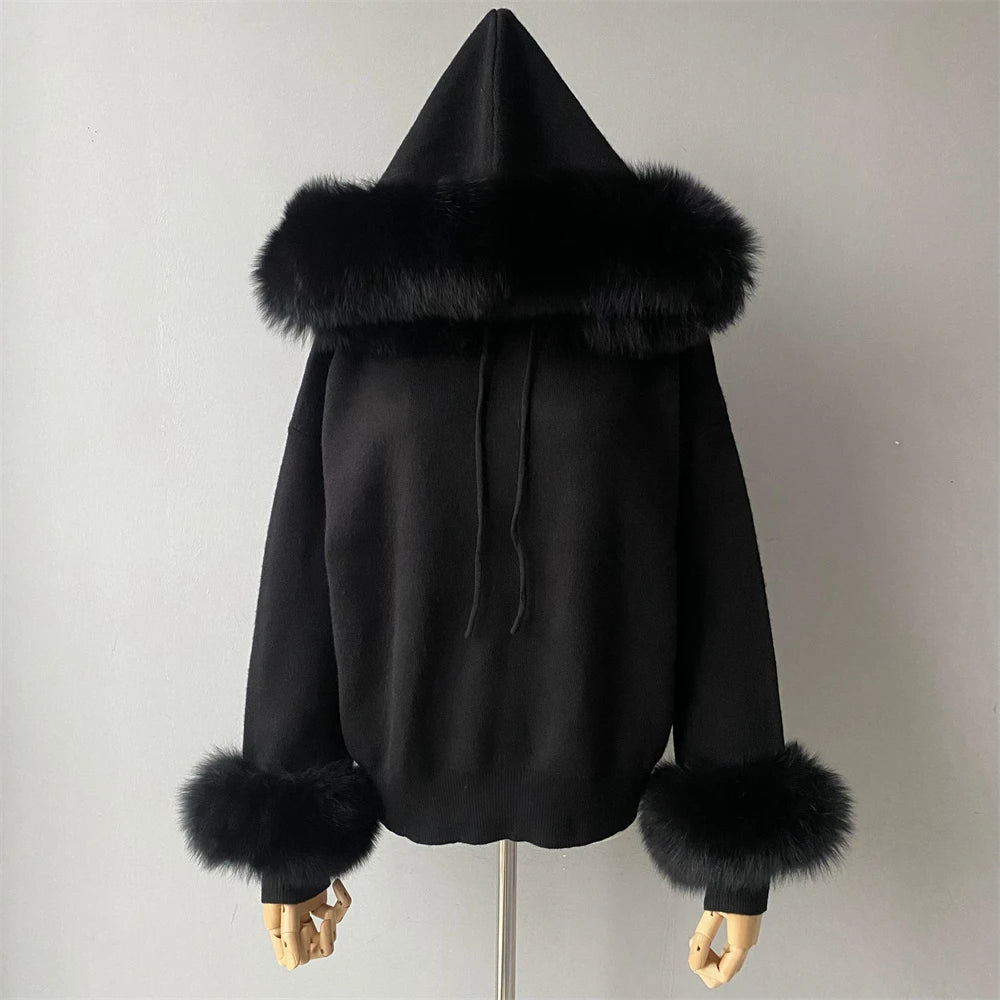 Black hoodie with fur trim on a mannequin against a plain background