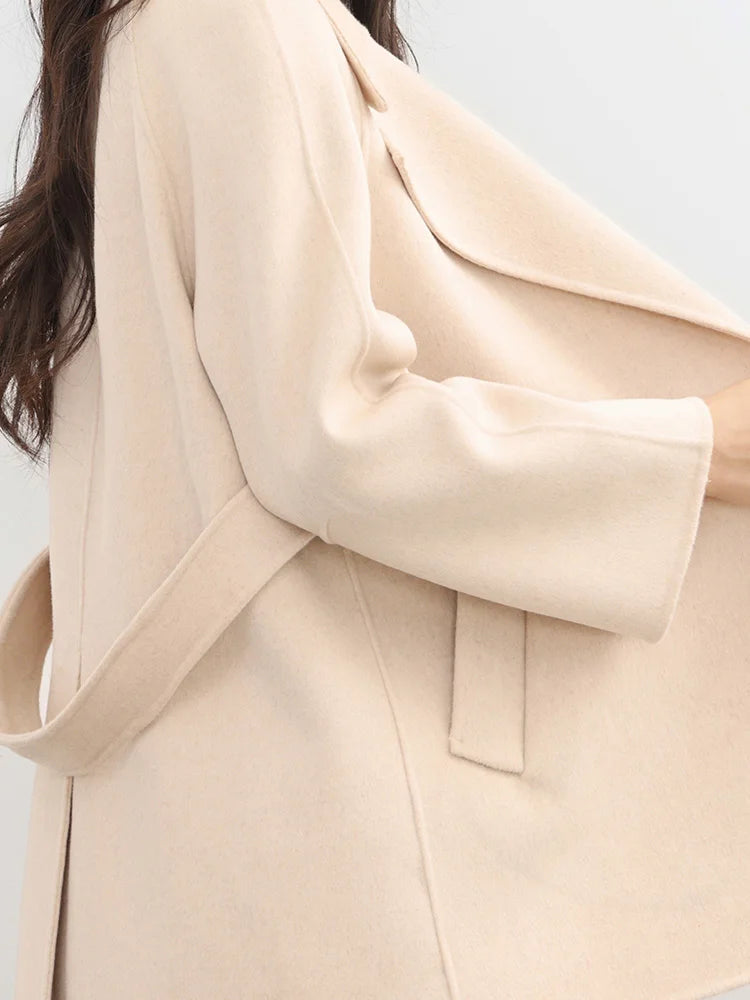 Close-up of a beige coat with a blurred background