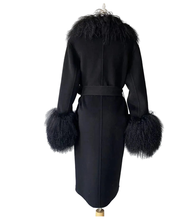 Black coat with feathered cuffs and collar on a mannequin against a white background