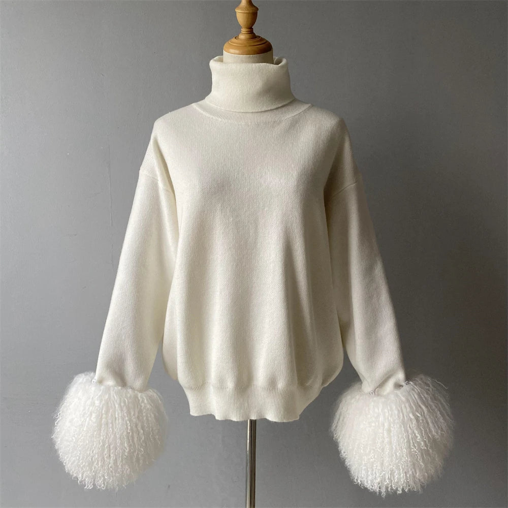 White sweater with fluffy cuffs on a mannequin against a gray background