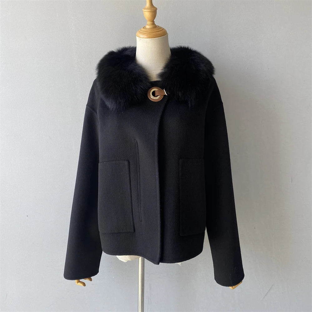Black coat with fur collar on a mannequin against a white background
