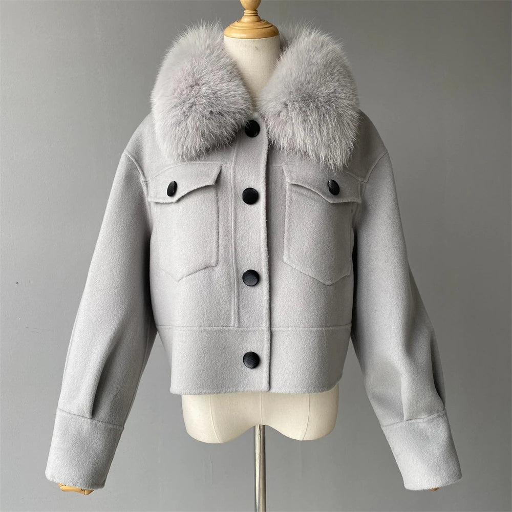Gray jacket with fur collar on a mannequin against a gray background