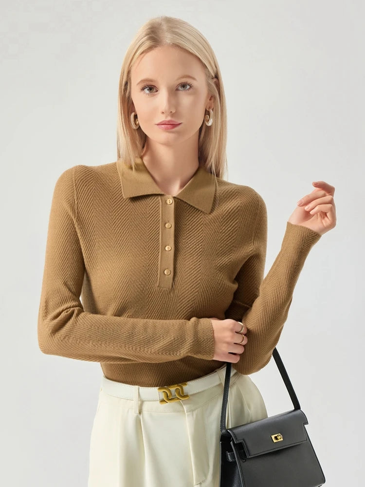 Woman wearing a brown knitted polo shirt and holding a black handbag on a light gray background