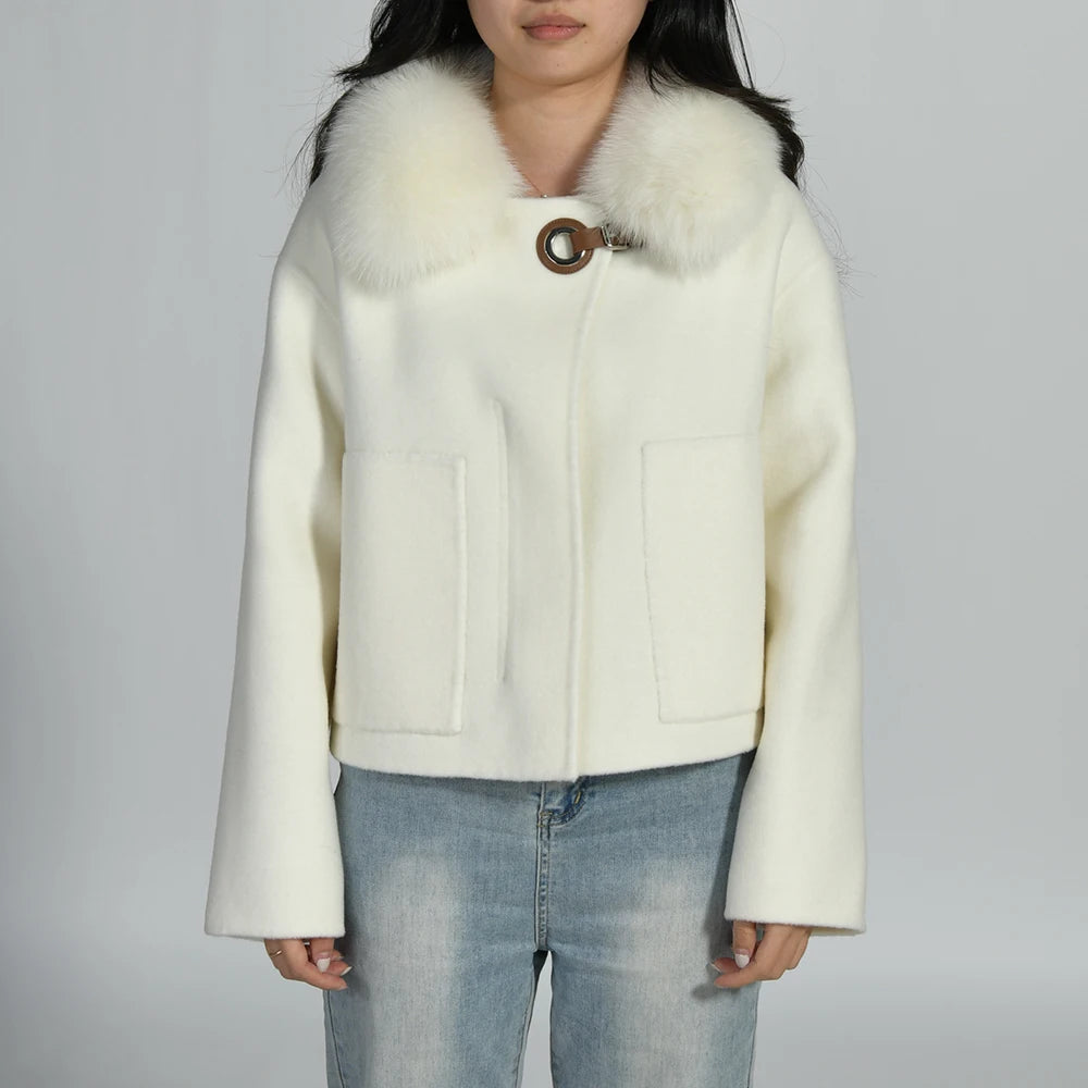 White coat with fur collar worn by a person on a plain background