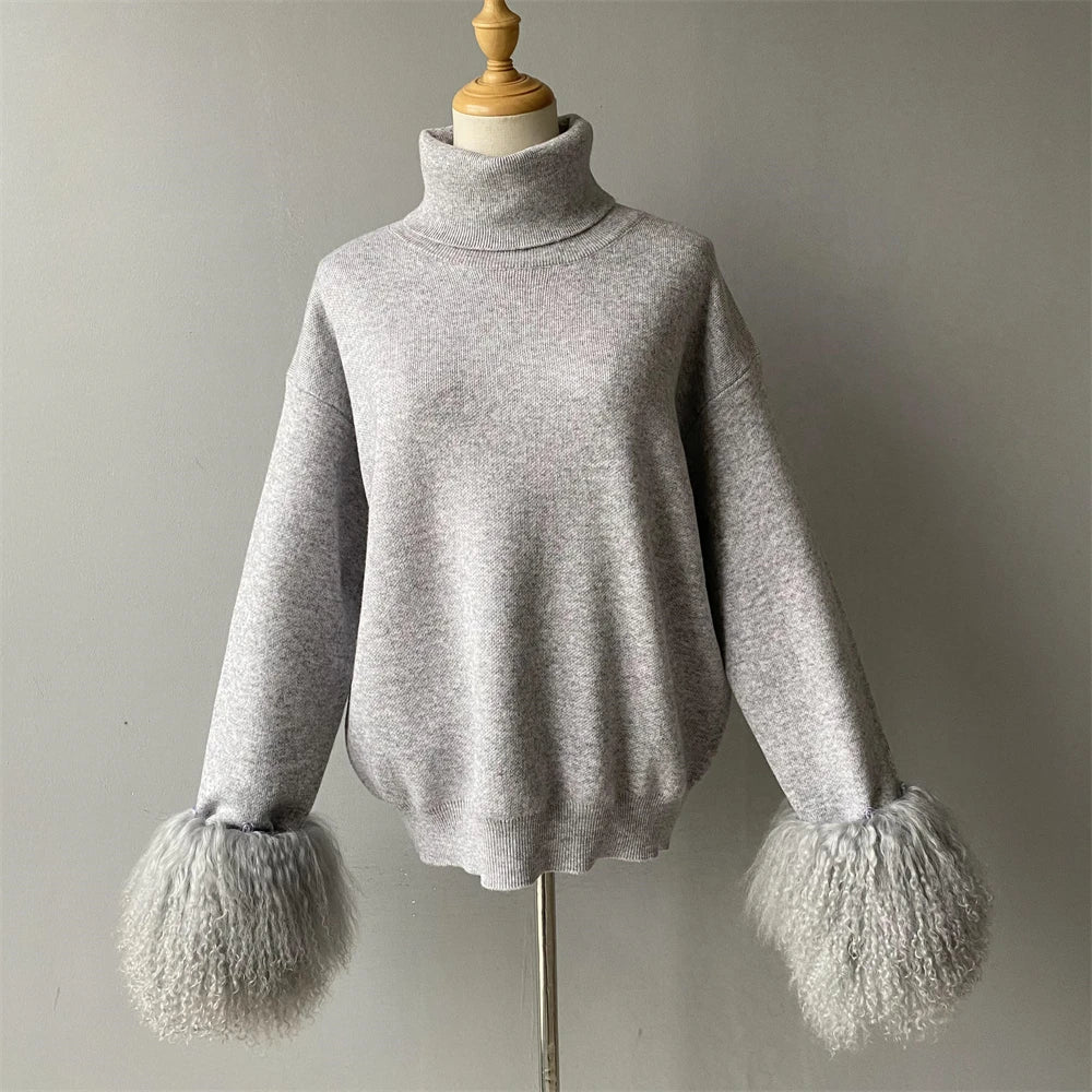 Gray sweater with fluffy cuffs on a mannequin against a plain background