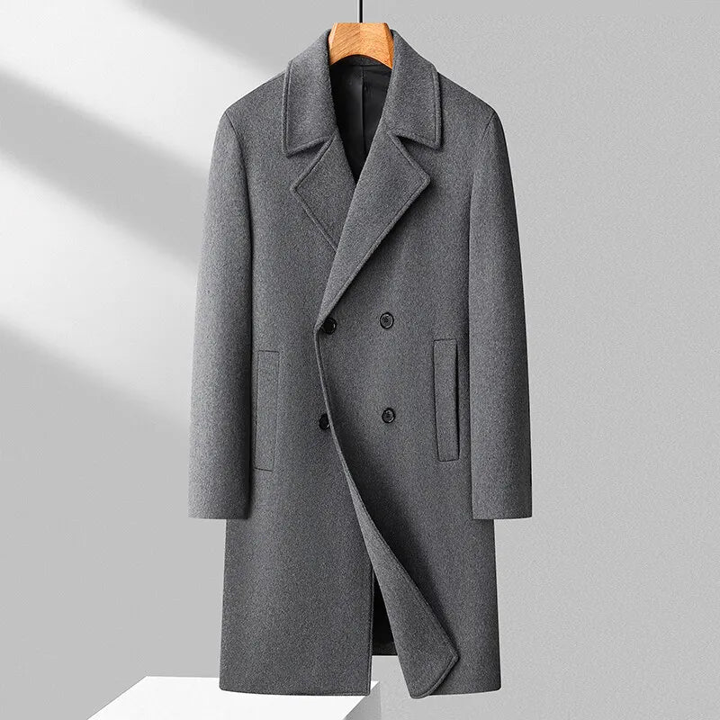 Gray overcoat on a hanger against a light gray background
