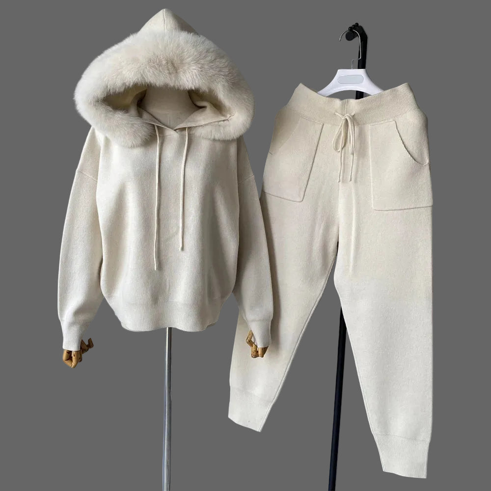 Beige hoodie with fur-lined hood and matching pants on a gray background