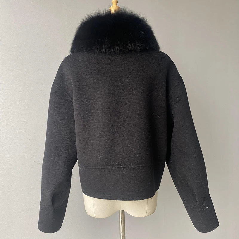 Dark gray jacket with black fur collar on a mannequin against a plain background