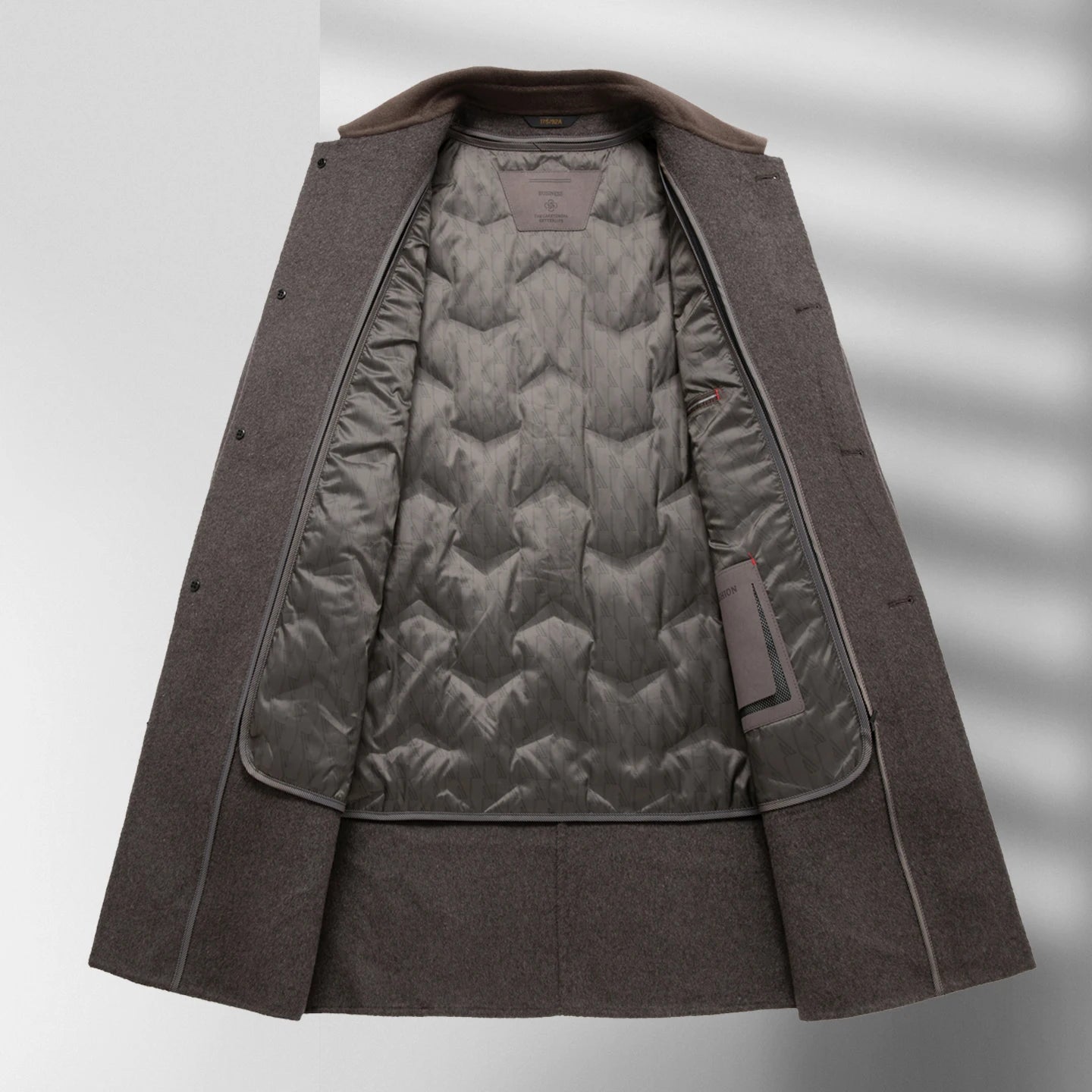 Brown coat with quilted lining on a white background
