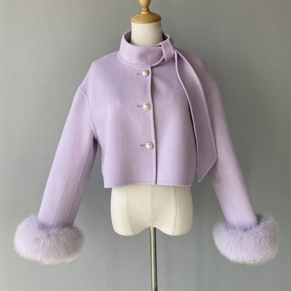 Lavender jacket with fur cuffs on a mannequin against a gray background