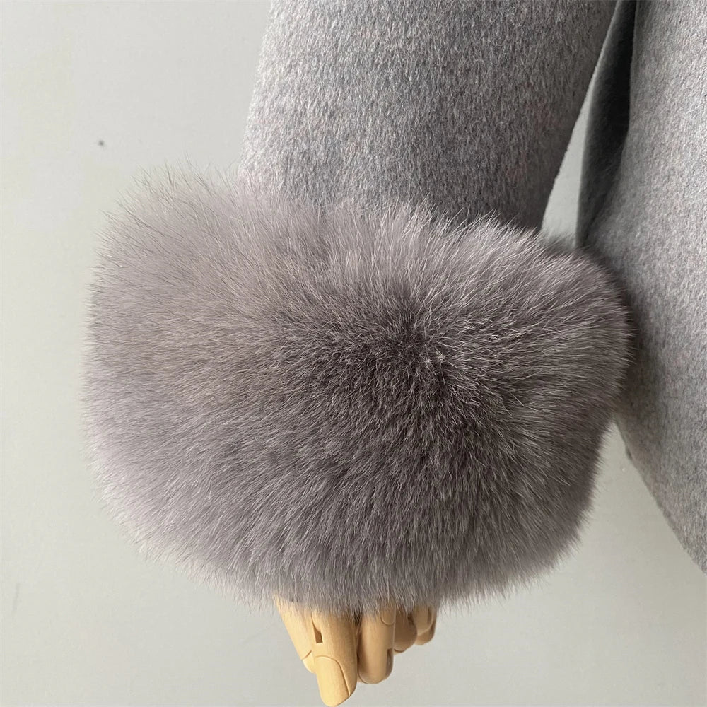 Gray fur wrist warmer on a mannequin hand against a light background