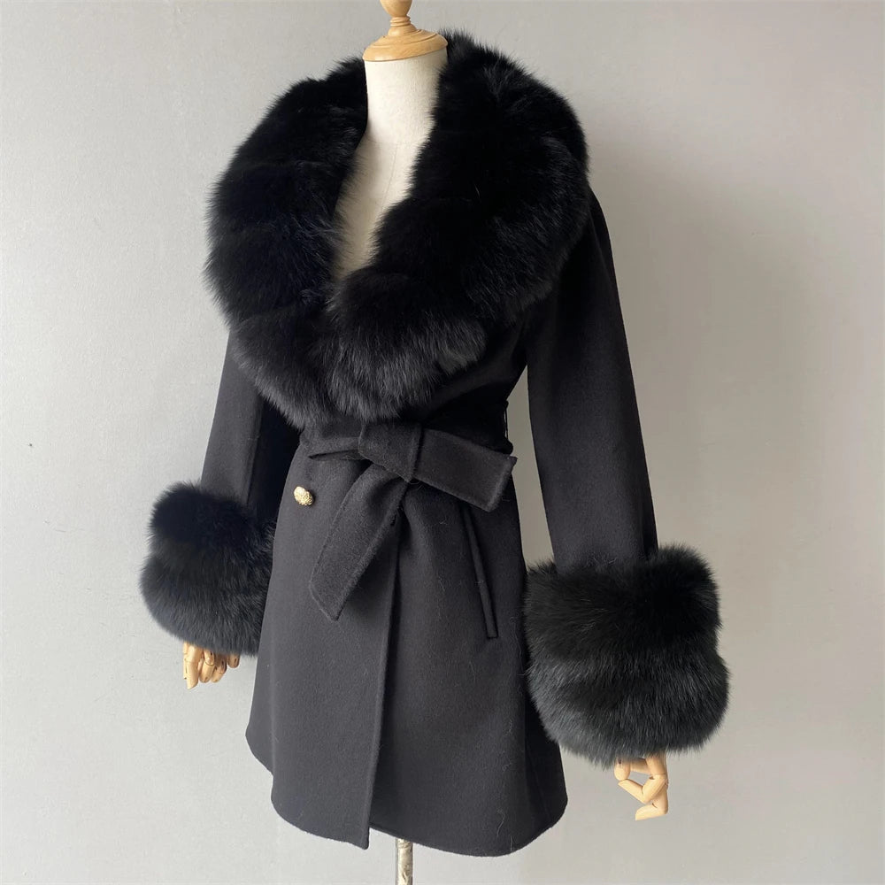 Black coat with fur trim on a mannequin against a plain background